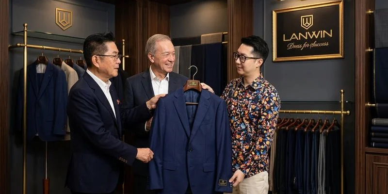 Completed bespoke suit being presented to the client at final collection